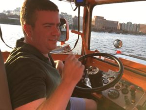Shane Wegner in a boat, sitting at the steering wheel.