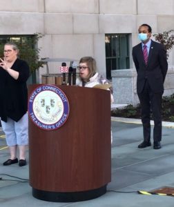 Jessica speaking at a podium