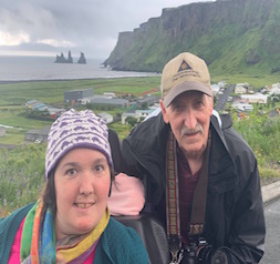 Emily Munson in front of water and cliffs in Iceland