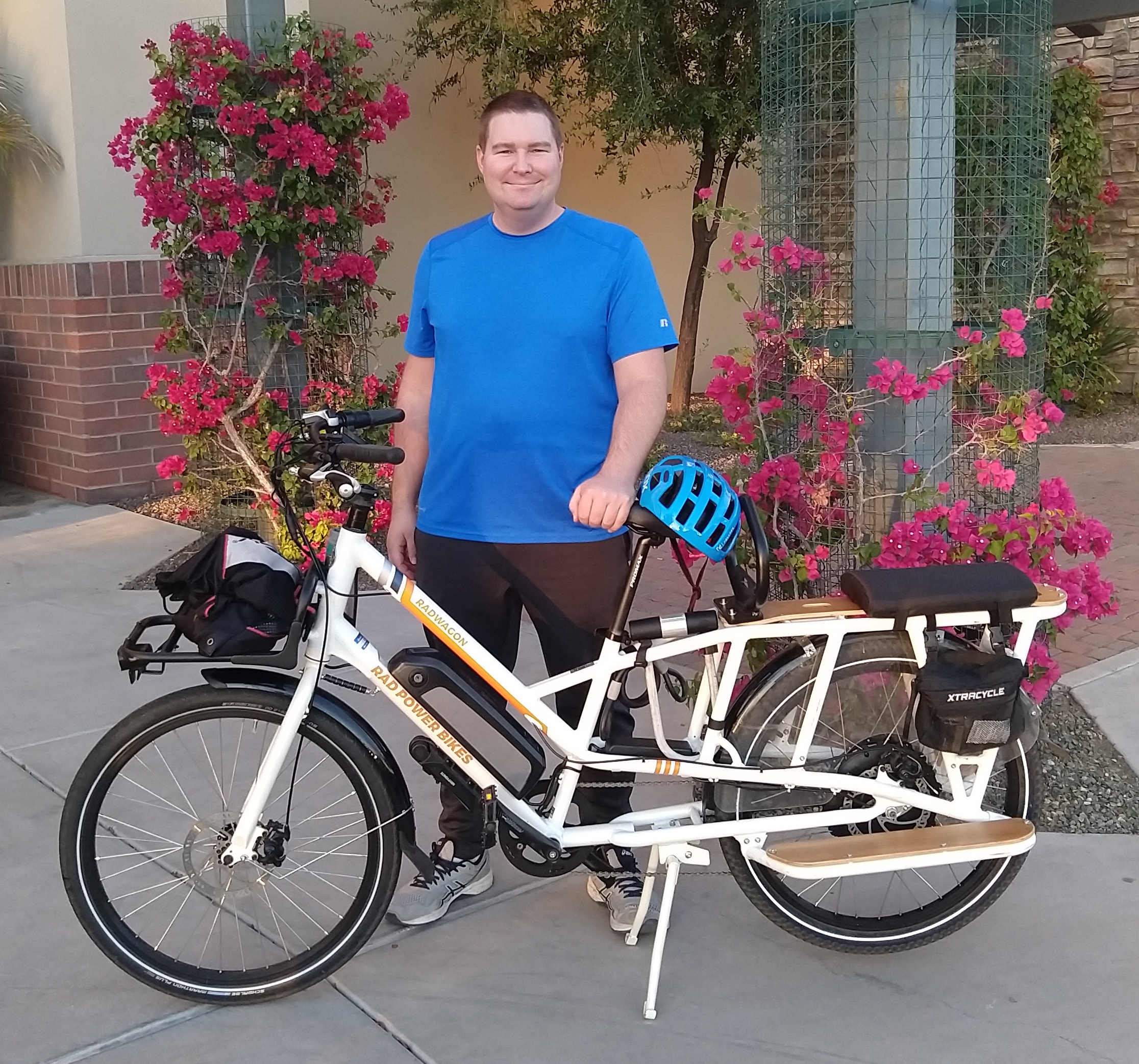 Nathaniel standing with his new bike outside.