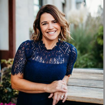 Professional photo of Kelley Land, a woman with shoulder-length brown hair, smiling for the camera.