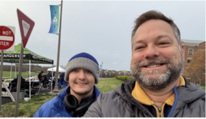 Kevin and his son Ian in and outdoor, picnic setting, by a tent
